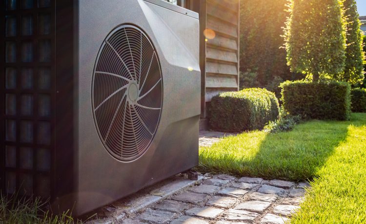 Air heat pump near pool house outdoors.